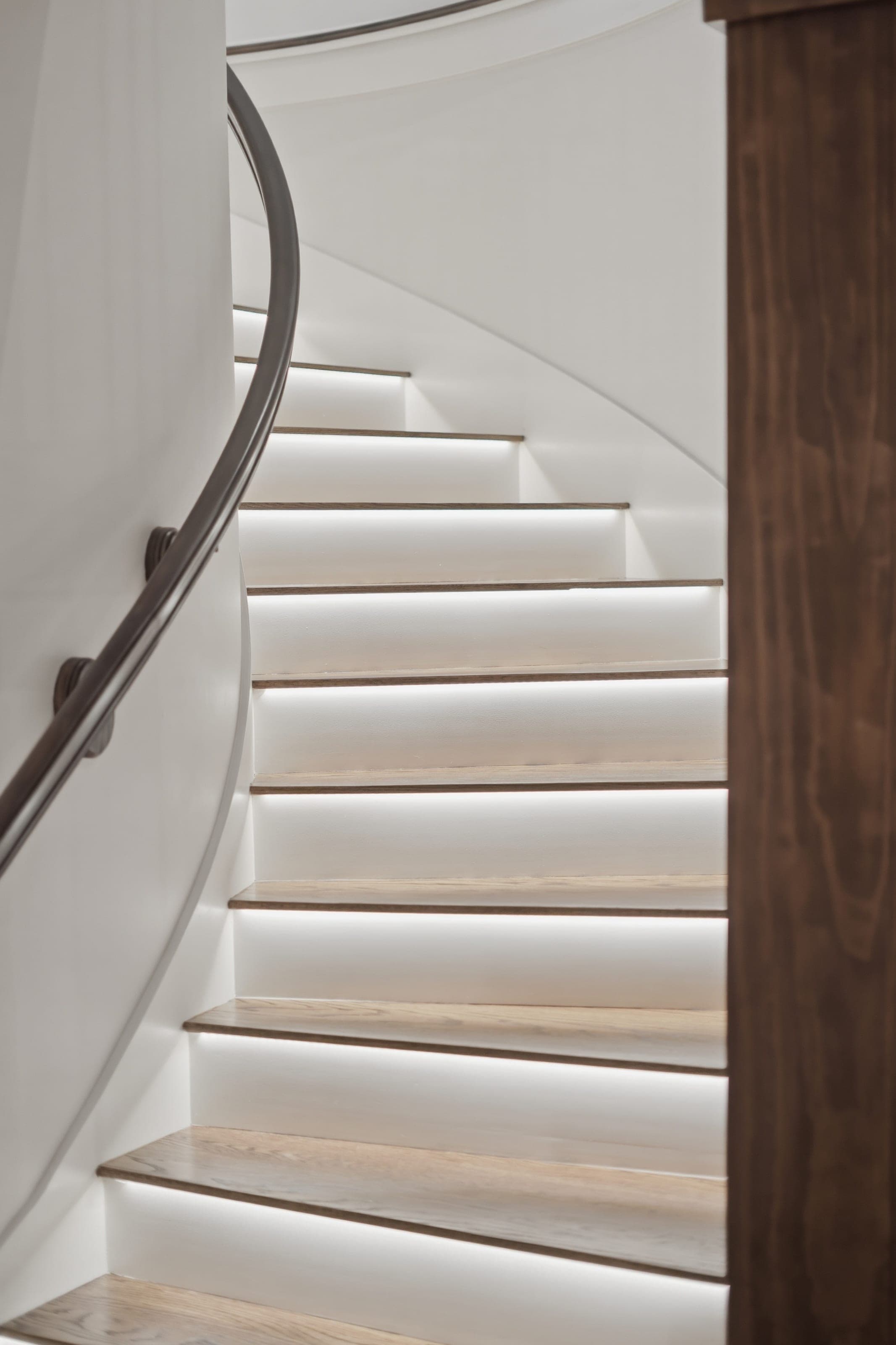 Curved staircase with illuminated risers and oak treads