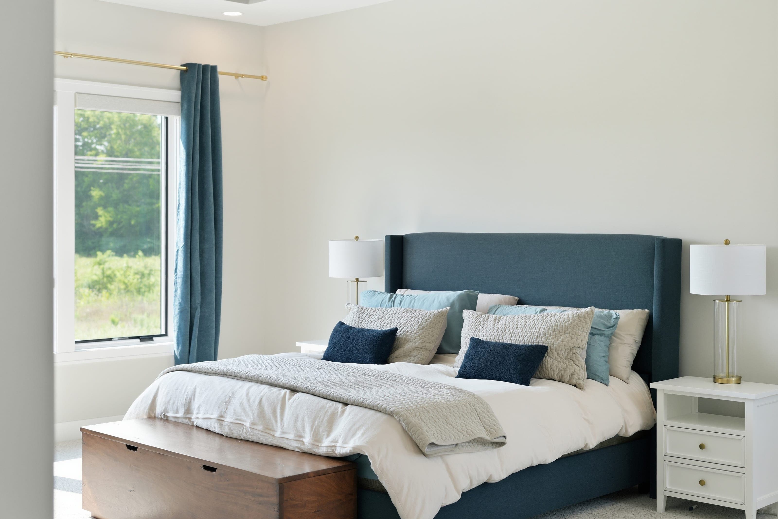 Primary bedroom with an upholstered navy headboard