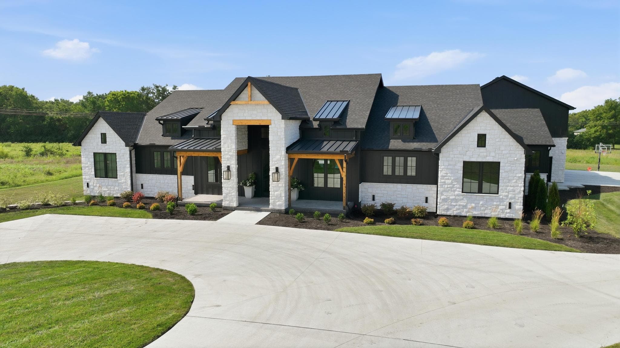 Low aerial over the front entry and garages