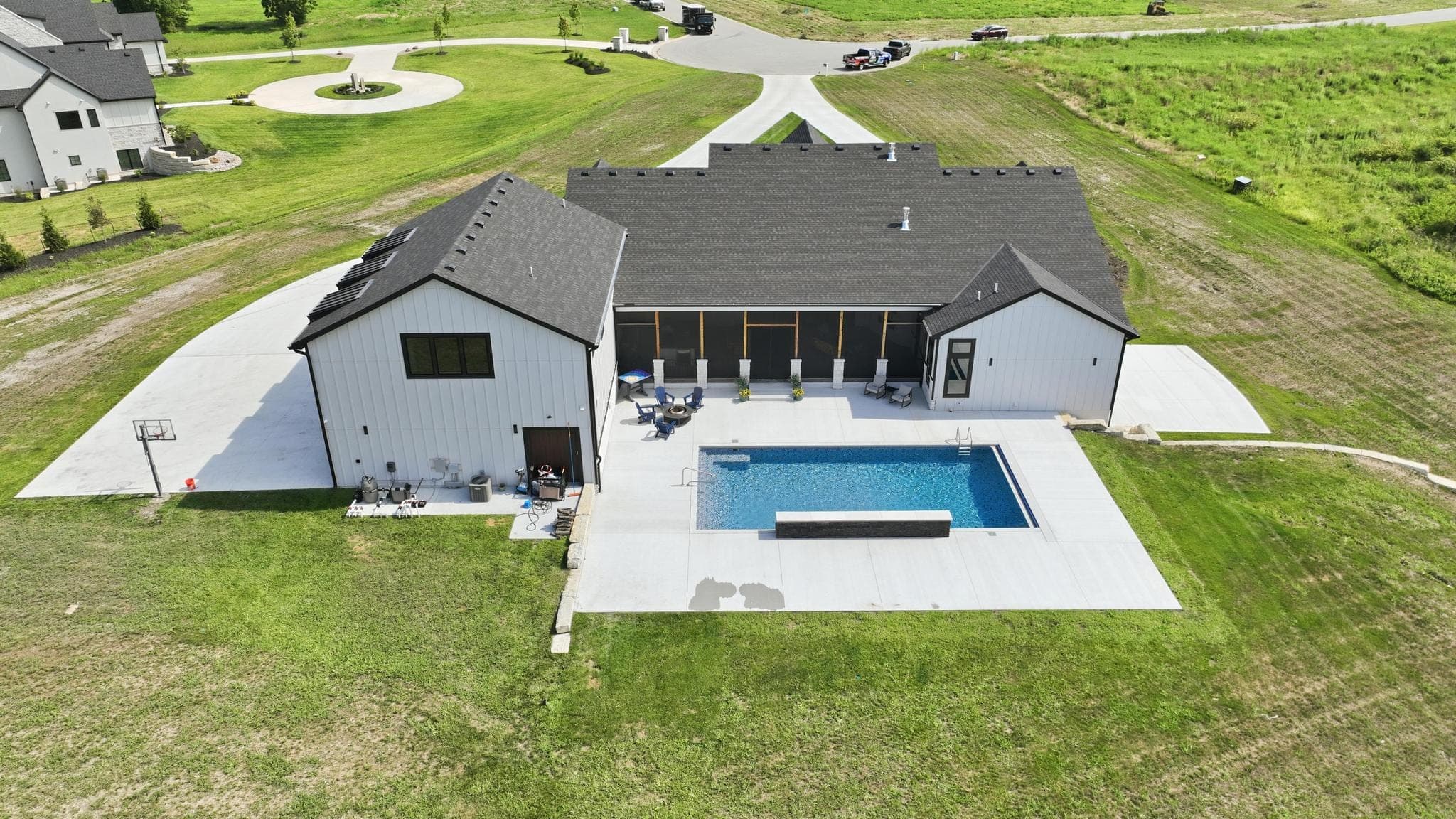 Low aerial of the rear of the house with pool and patio