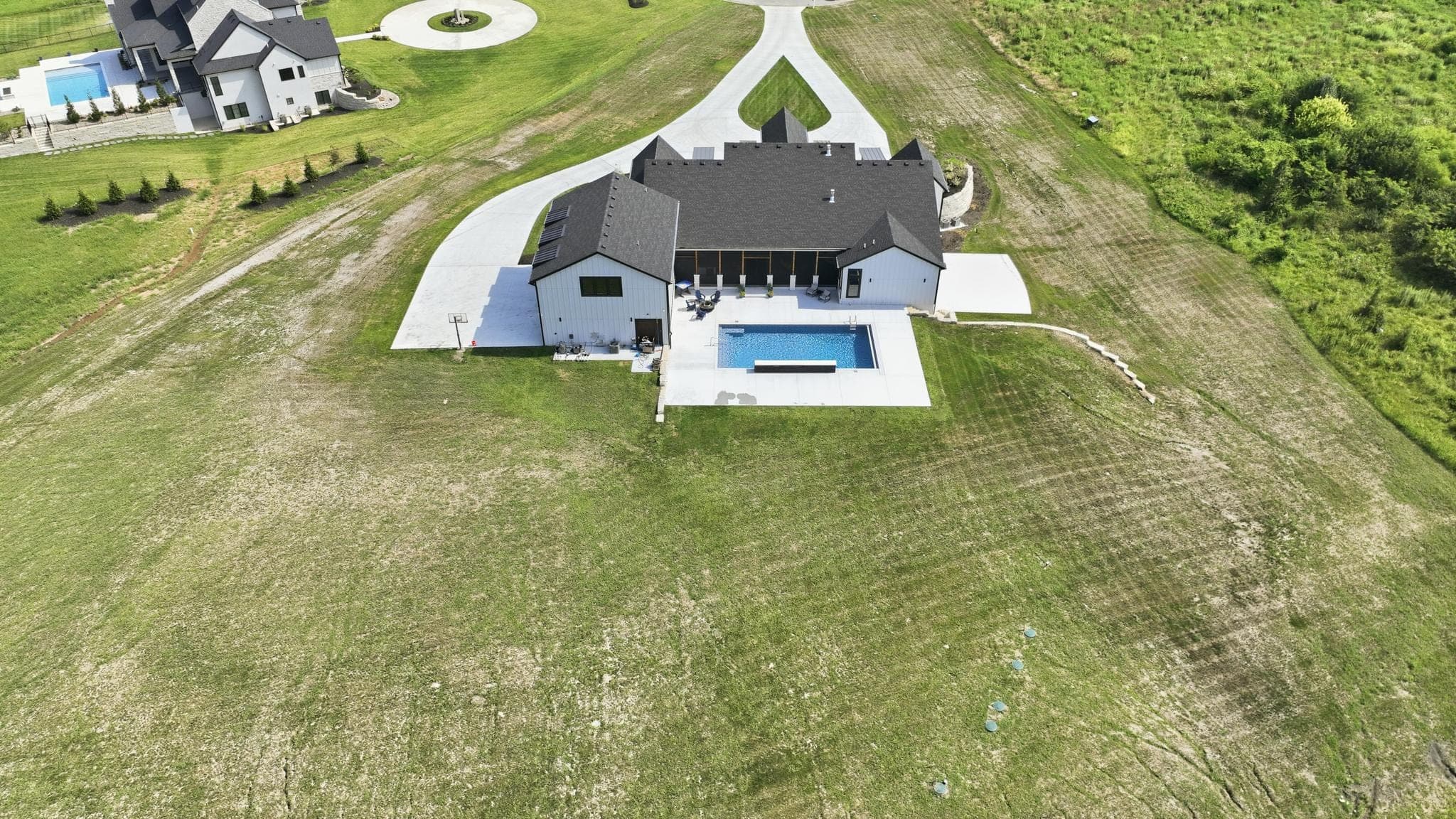 Aerial of the rear elevation, pool and patio