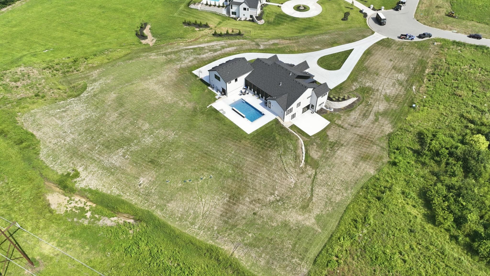 High aerial of the side of the house and pool