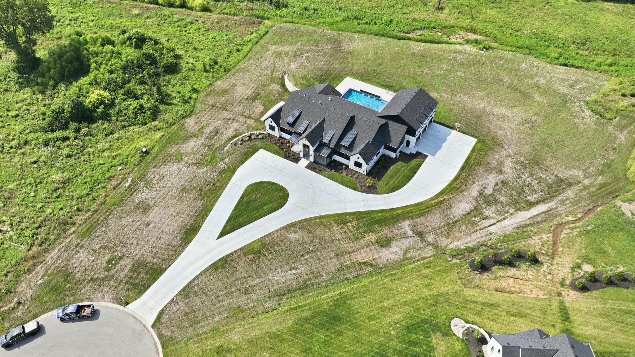High aerial showing the full lot, drive and surrounding fields