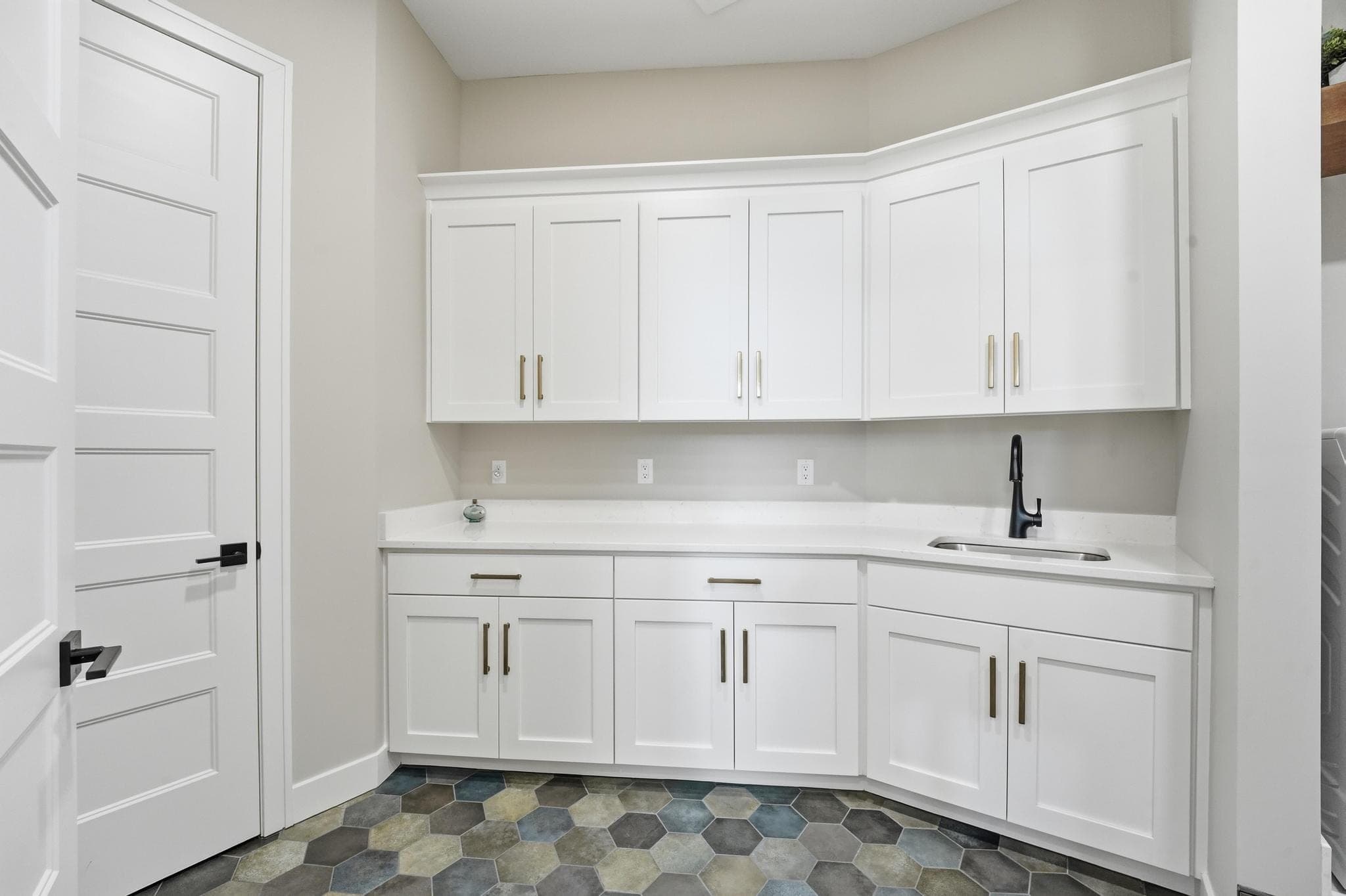 Laundry room cabinetry with sink