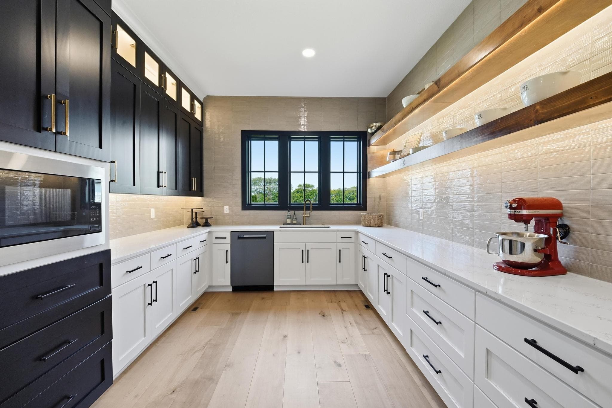 Prep kitchen with black upper cabinets and white lowers