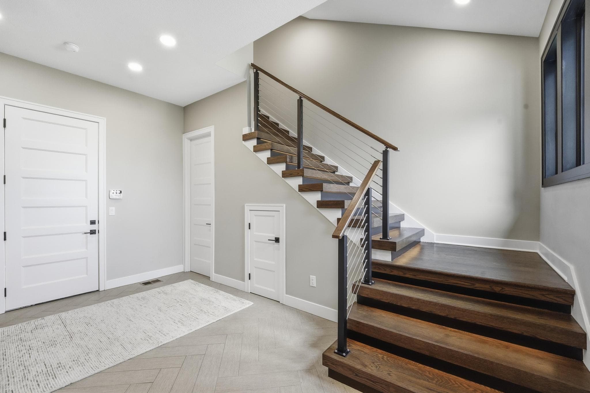 Wood staircase with black metal railing
