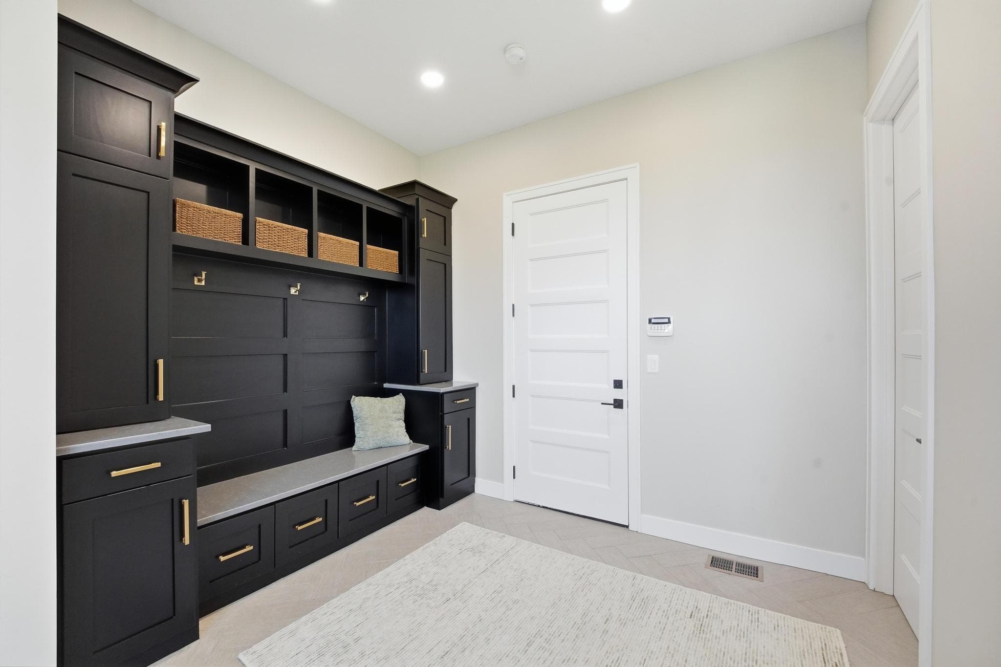 Mudroom with black lockers and bench