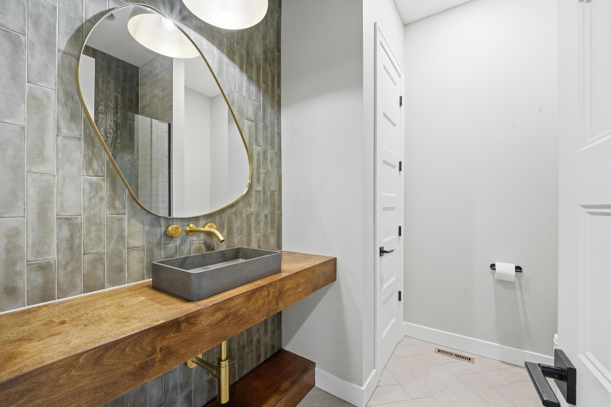 Guest bath with a wood vanity and vessel sink