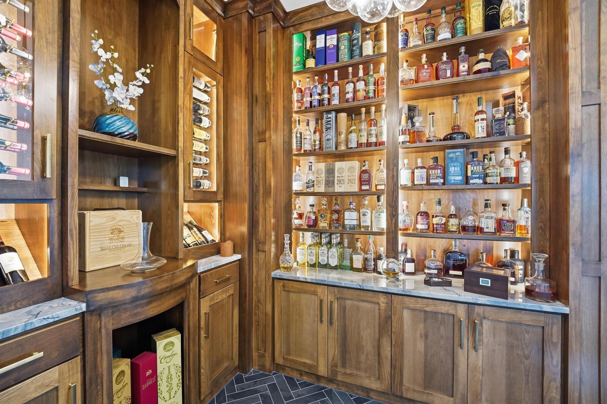 Wood bar with backlit shelving and bottle display