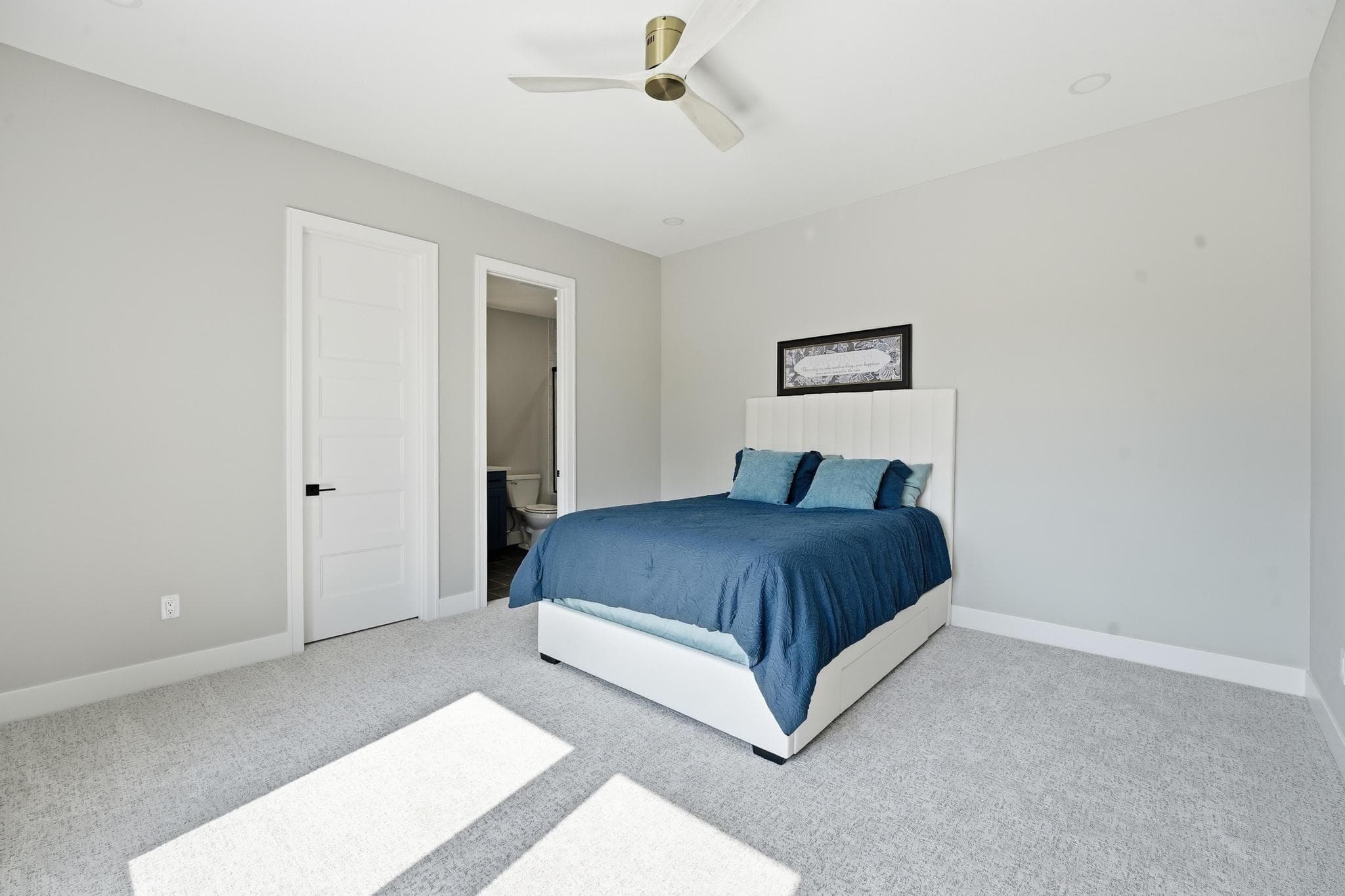 Lower level bedroom with a blue bed
