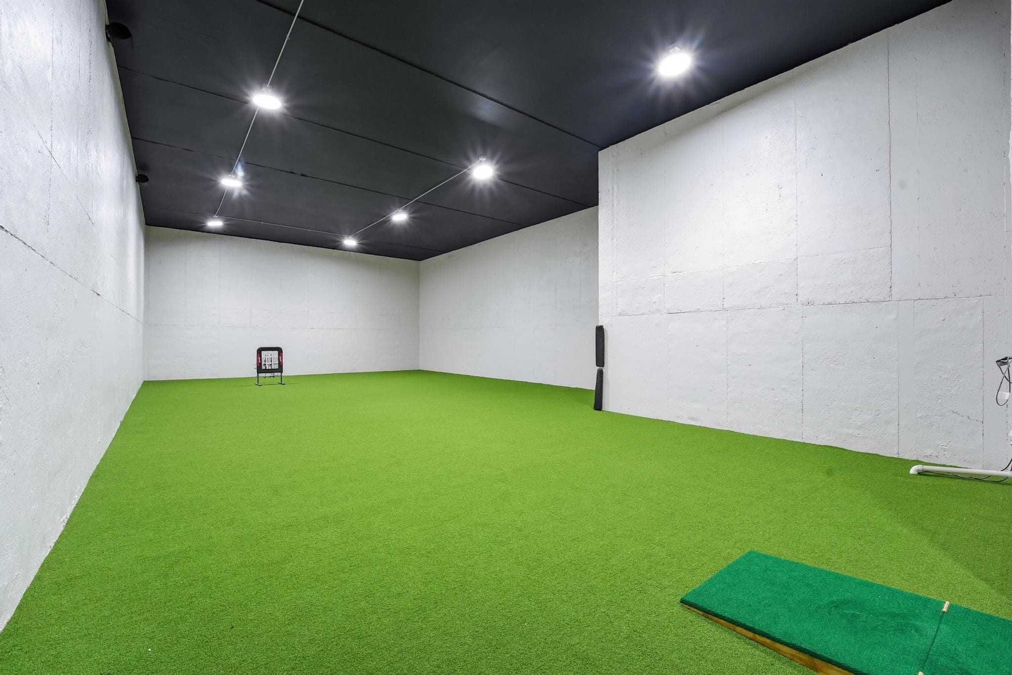 Indoor turf room with a black ceiling