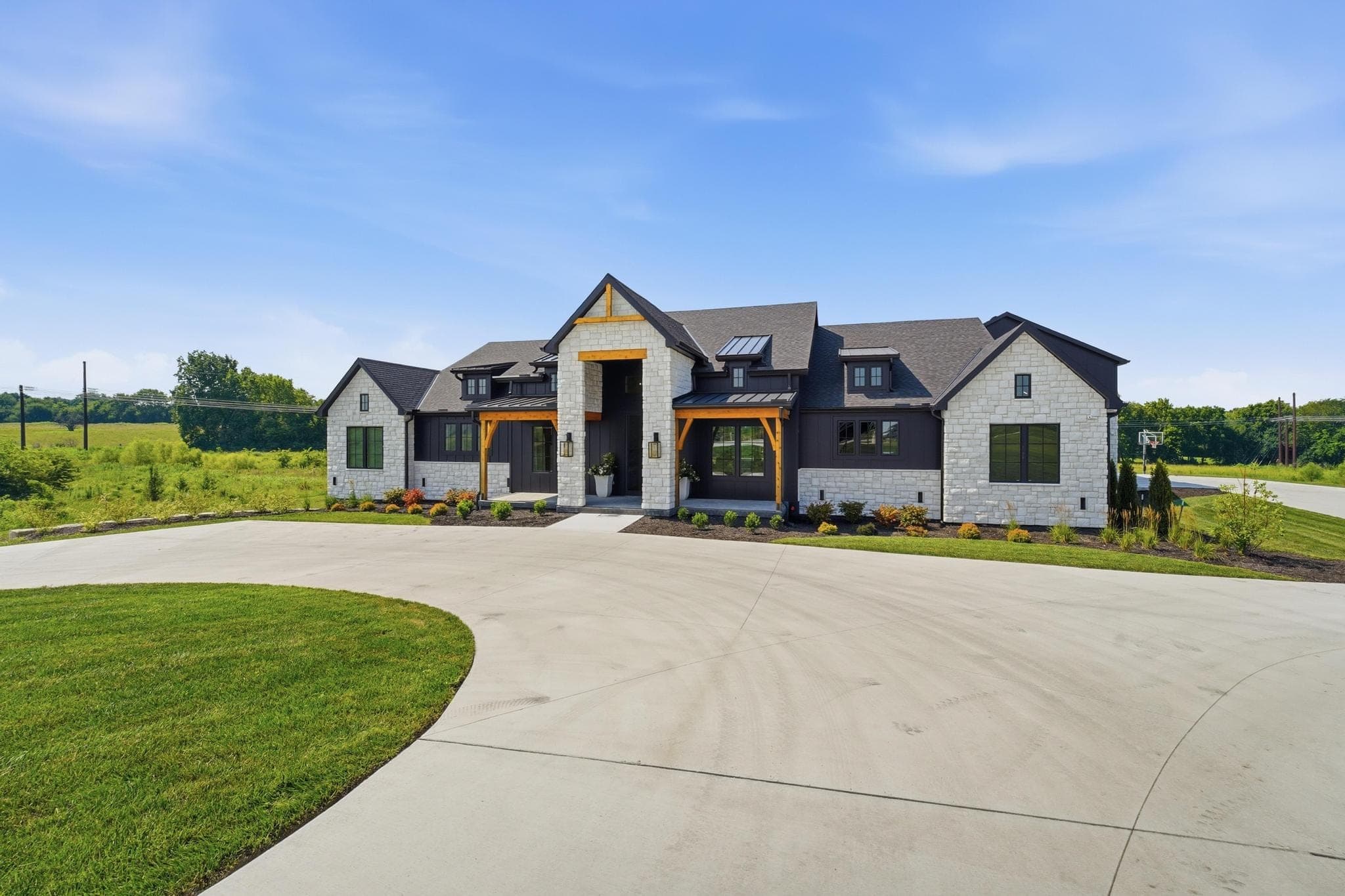 Modern farmhouse from the end of the concrete circular drive