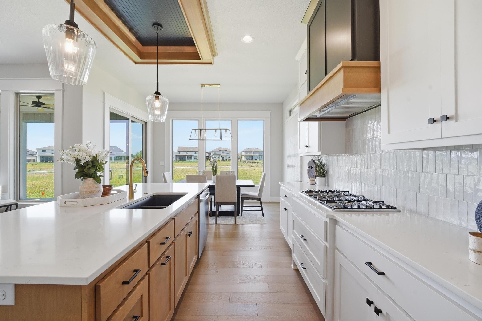 Kitchen island with pendants and range beyond