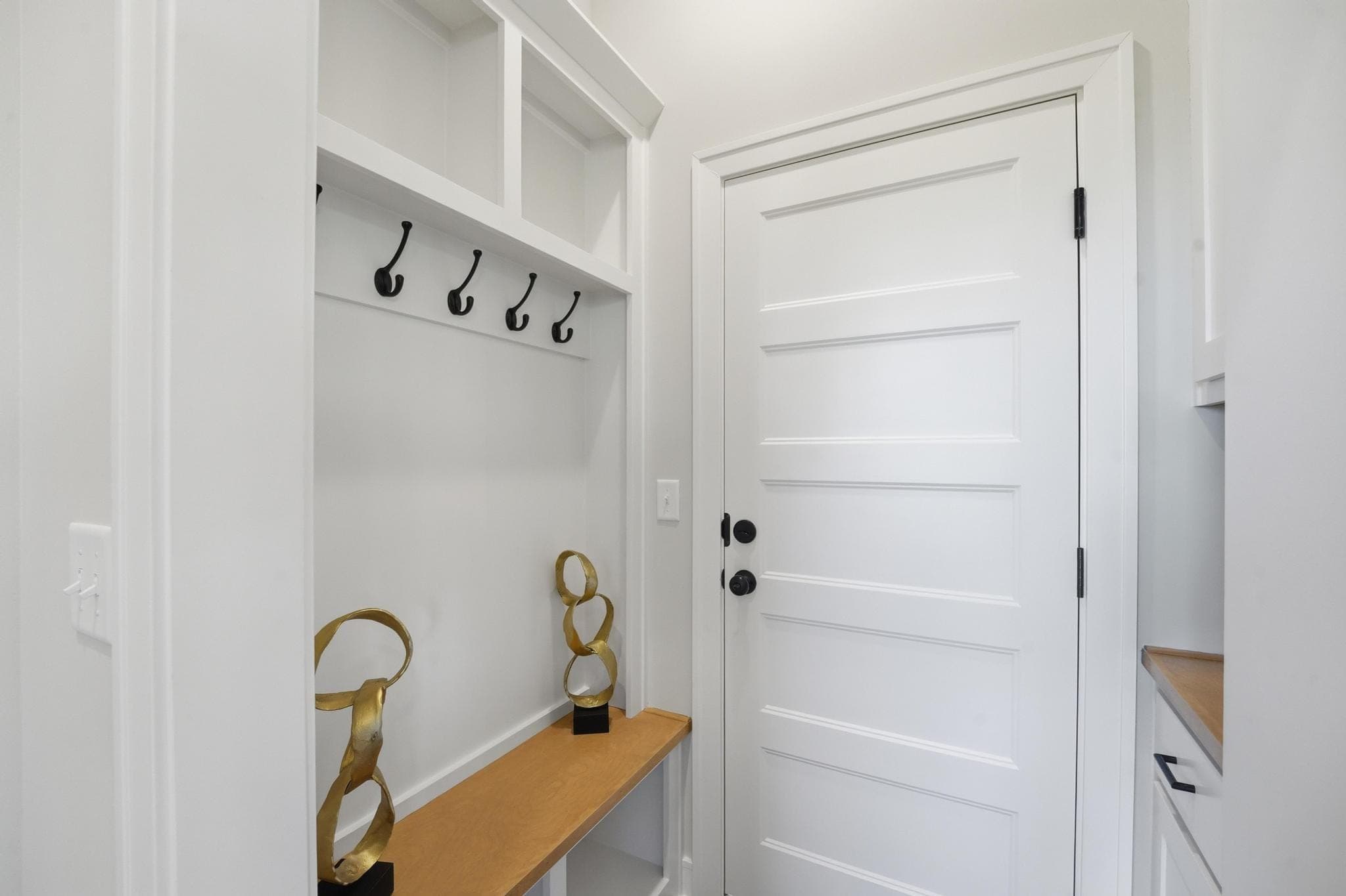 Mudroom drop zone with hooks and bench