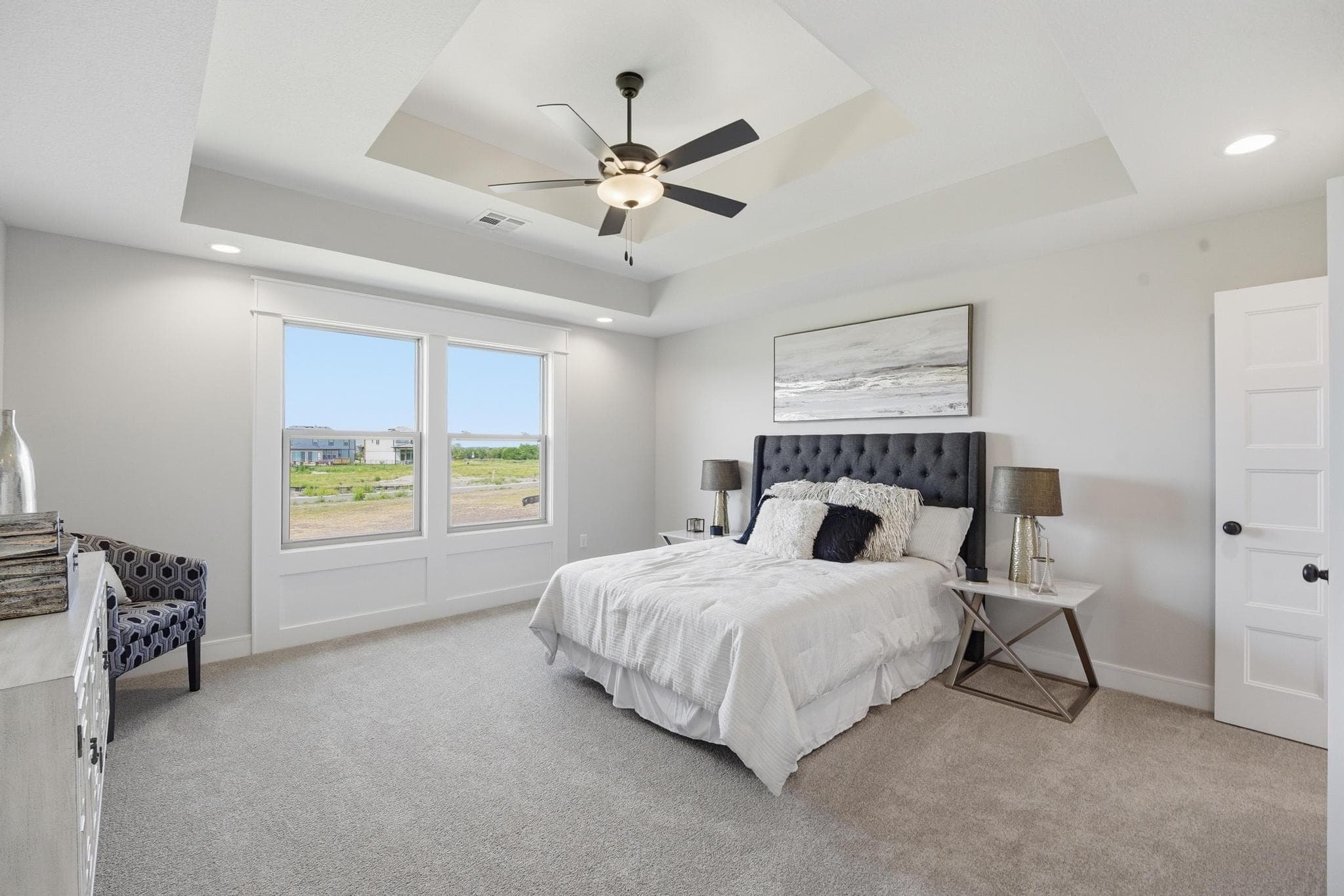 Primary bedroom with a tray ceiling