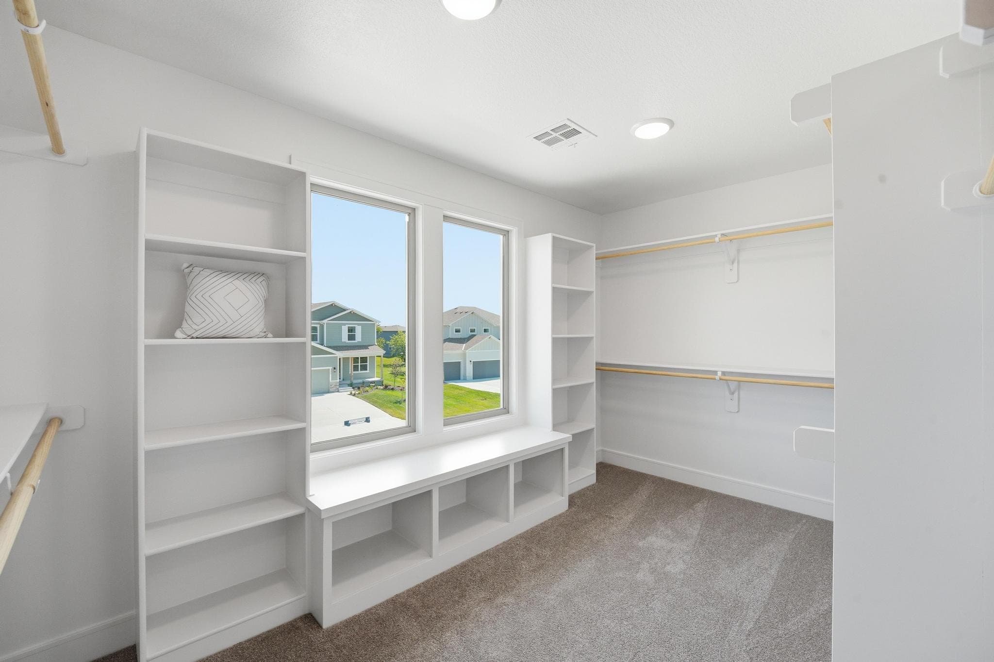 Walk-in primary closet with built-ins